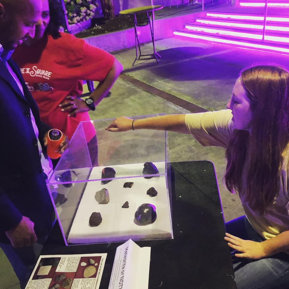 A student is seen interacting with an exhibit