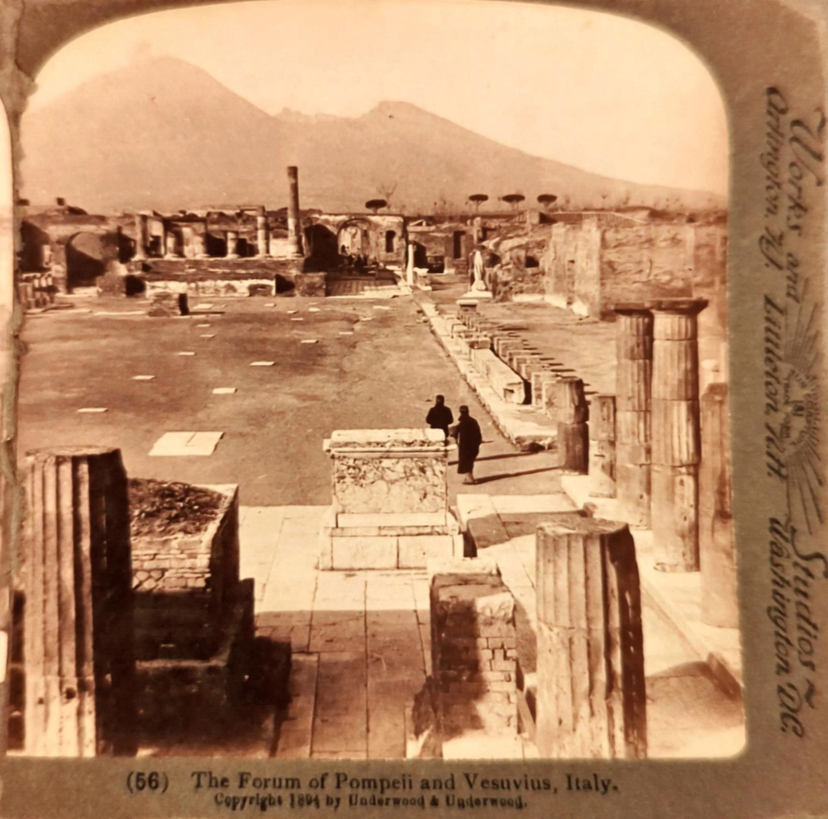 A black and white stereograph image of a historic site with building ruins. At the bottom it says "The Forum of Pompeii and Vesuvious, Italy."