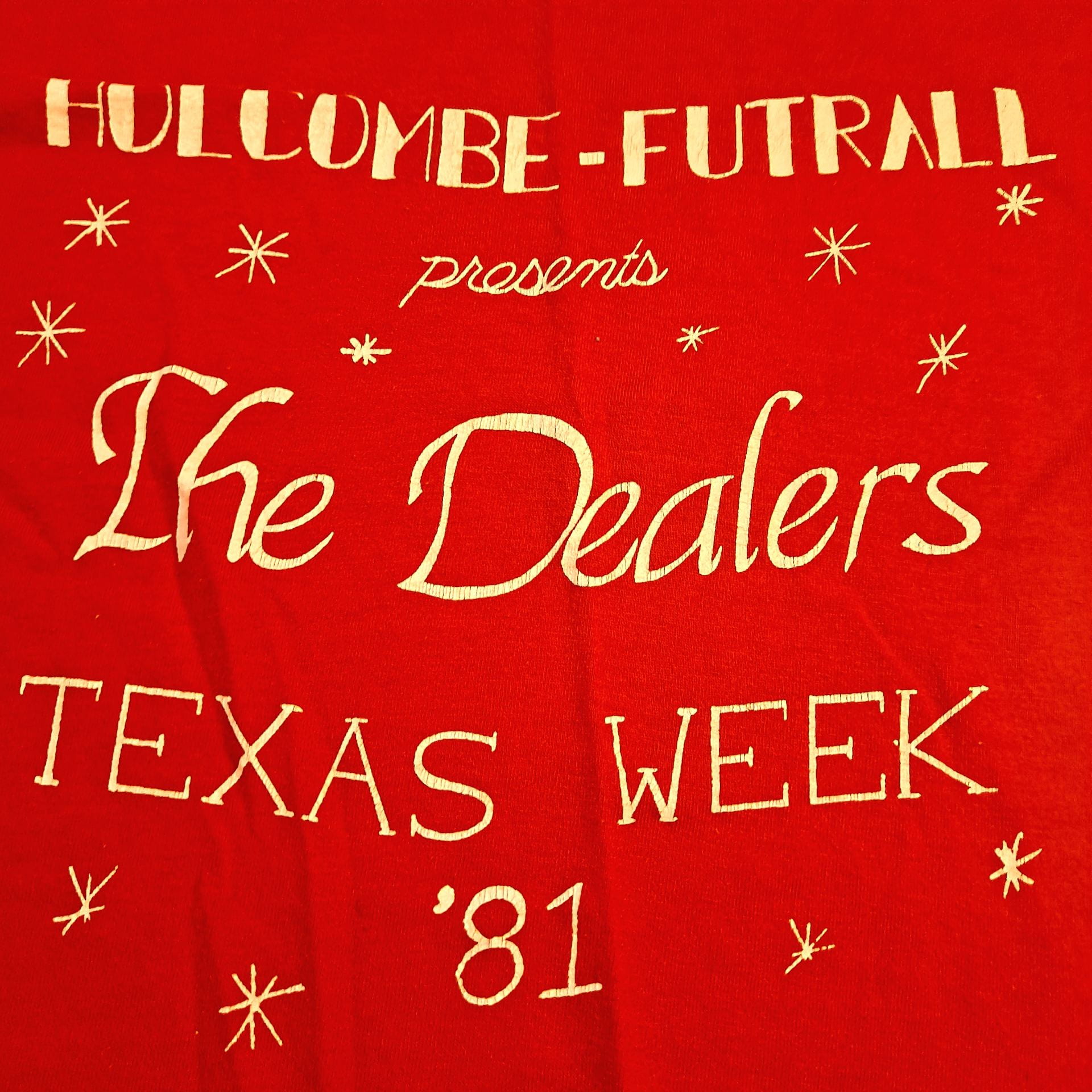 Close-up of a red t-shirt that says "Holcumbe-Futrall presents The Dealers Texas Week '81"