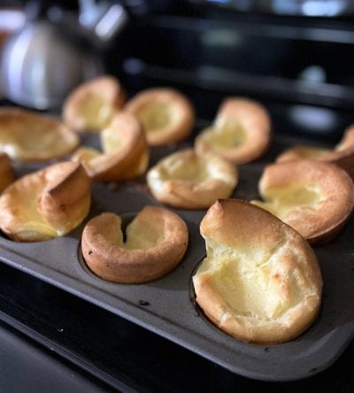 Yorkshire Pudding still in the pan, sitting on stove