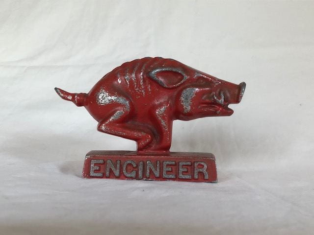 A dark red running Razorback figurine with "Engineer" along the pedestal.