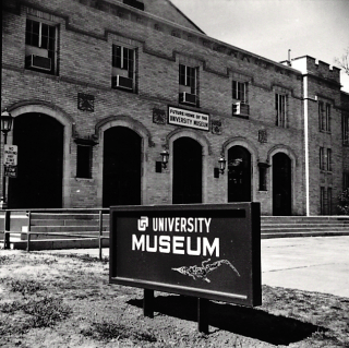 Black and white photo of Museum sign when located at Men's Gym on campus.