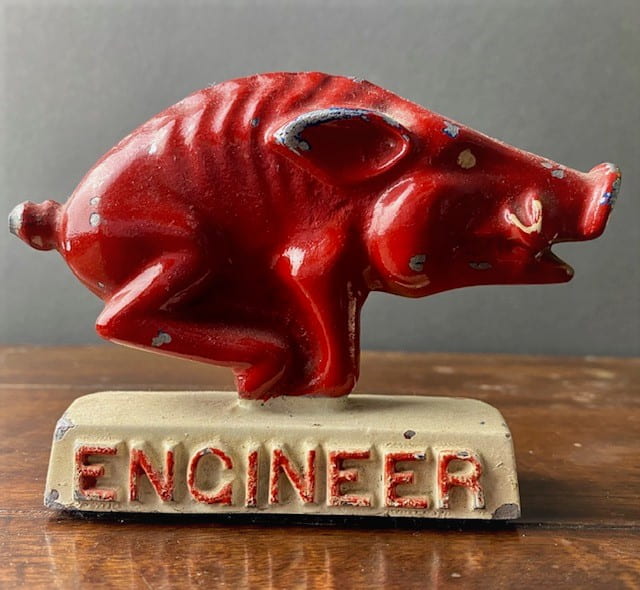 A red ceramic Razorback figurine with the word "Engineer" underneath.