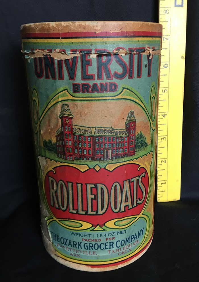 A cardboard container of "University Brand Rolled Oats." Has a blue background with Old Main in the center.